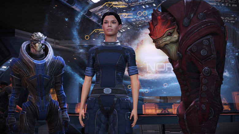 Garrus, Shepard, and Wrex stand by the galaxy map in Mass Effect