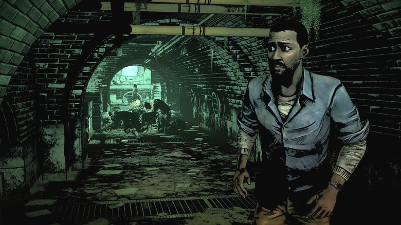 Lee Everett sneaks past zombies in the sewers in The Walking Dead