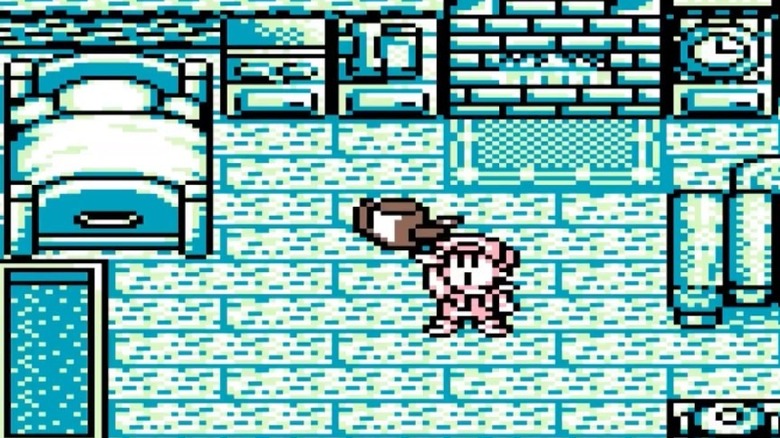 The player character holds up a water can in Harvest Moon GB