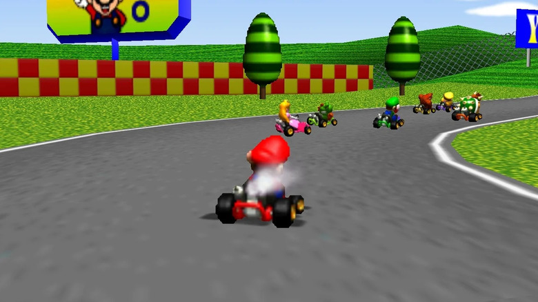 Mario follows other racers around a corner in Mario Kart 64