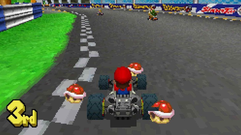 Mario turns a corner with three red shells in Mario Kart DS