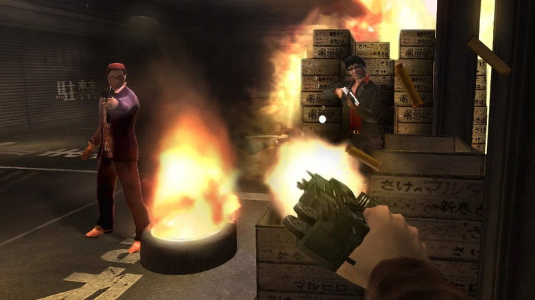 Scott Monroe fires a submachine gun at enemies in a burning warehouse in Red Steel