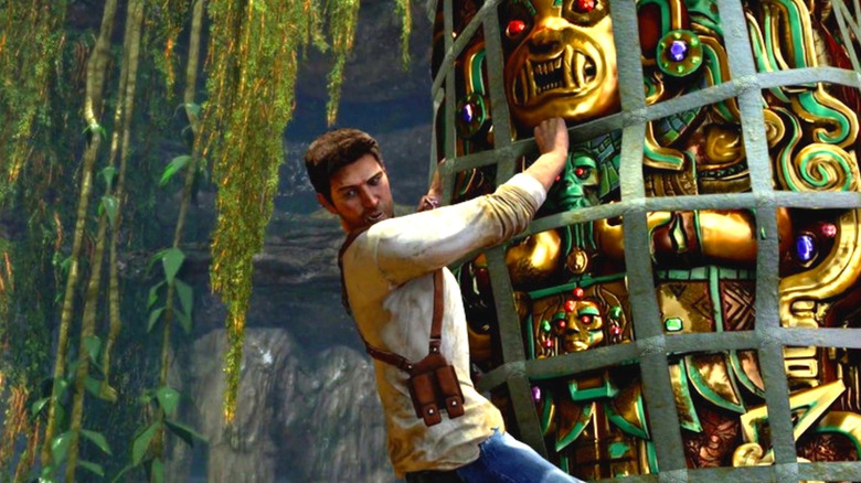 Nathan Drake hangs from a golden idol in a net in Uncharted: Drake's Fortune