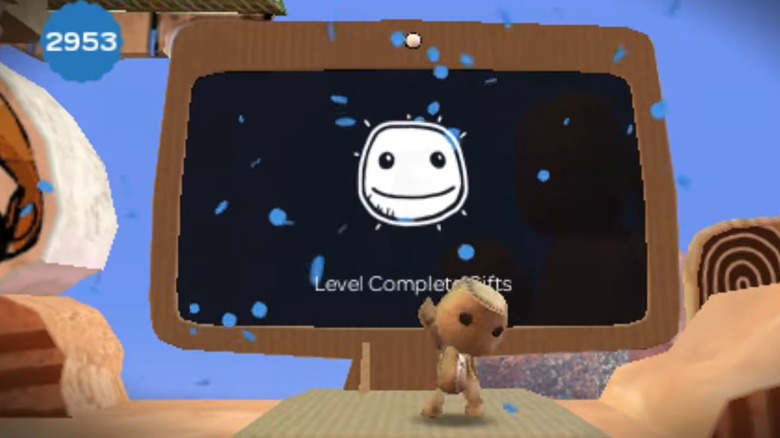 Sackboy completing a level in LittleBigPlanet on PSP