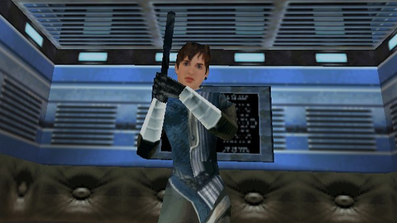 Joanna Dark stands in an elevator holding a pistol in Perfect Dark