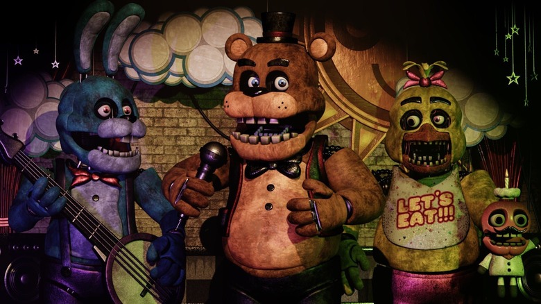 The Bonnie, Freddy Fazbear, and Chica animatronics perform on stage in "Five Nights at Freddy's" (2014)
