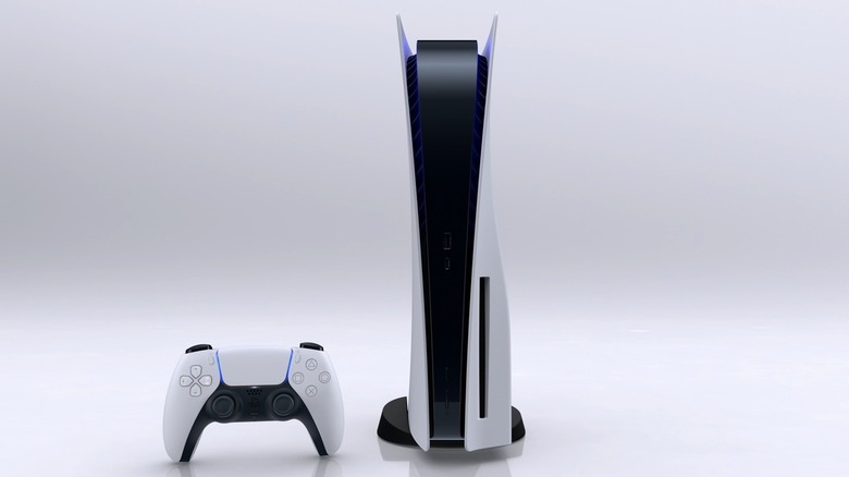 A PlayStation 5 rests next to a DualSense controller