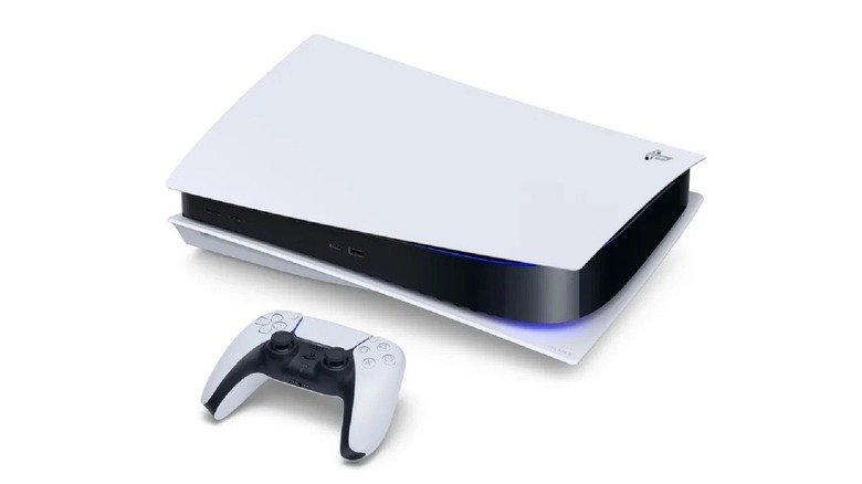 A DualSense controller rests in front of a PlayStation 5