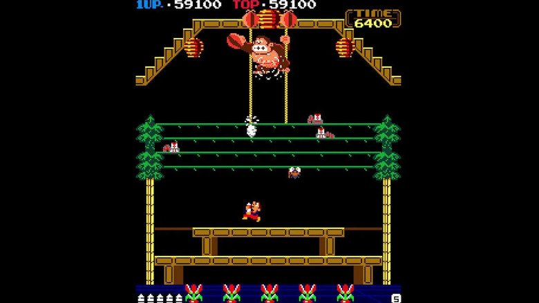 Stanley sprays Donkey Kong as he reaches for fruit in "Donkey Kong 3" (1983)