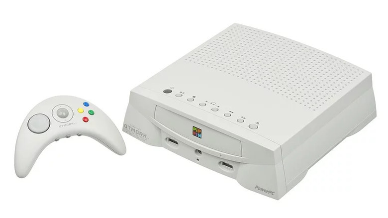 An Apple Pippin with its controller on a white background
