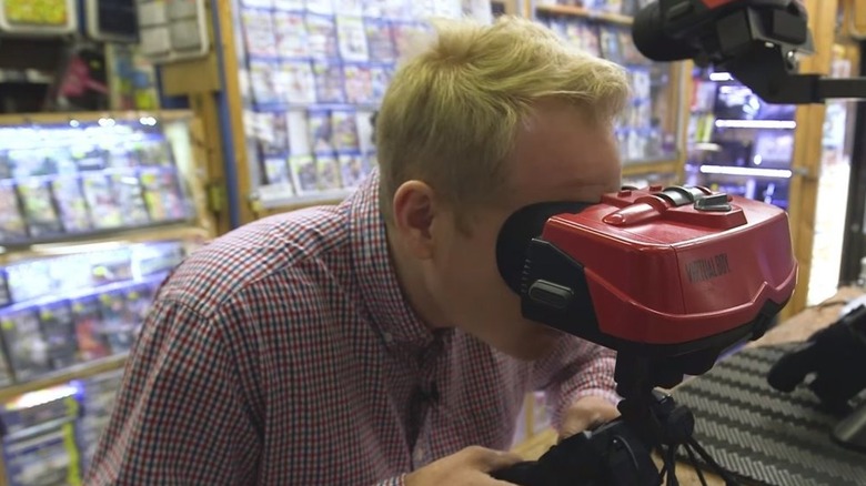 A man looks into a Virtual Boy in a video game store