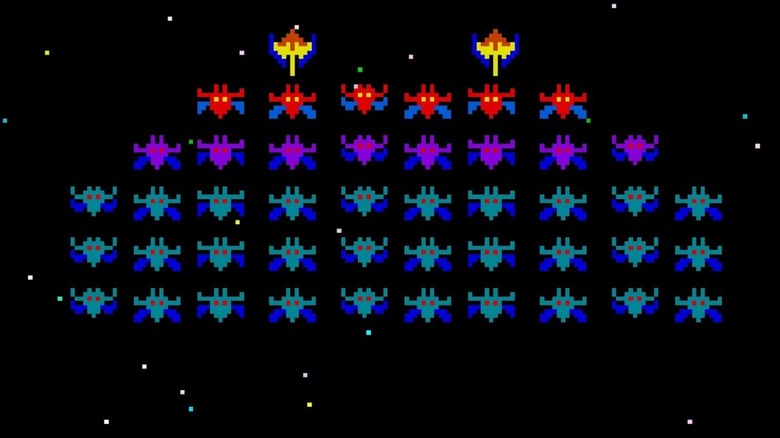 A row of spaceships descend from the cosmos in Galaxian