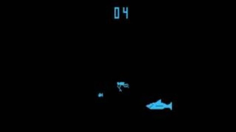 A shark approaches a diver pursuing a fish in Shark Jaws