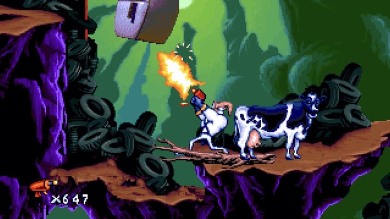 Earthworm Jim stands next to a cow while under a refrigerator in Earthworm Jim