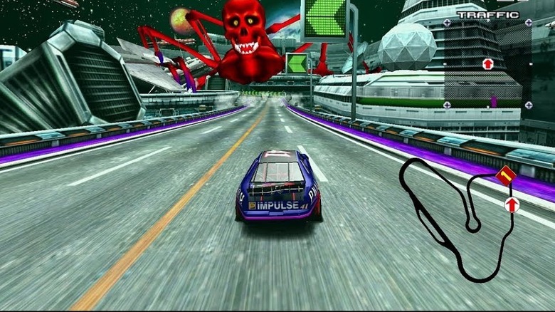 A race car drives towards a red skull-faced spider in Daytona USA 2: Power Edition