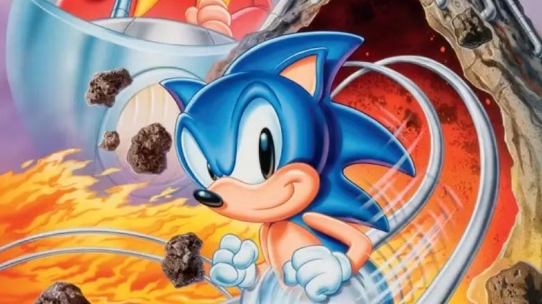 Sonic the Hedgehog runs along a silver track over flames on the cover art for Sonic Spinball