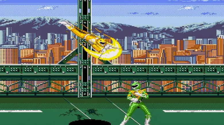 The Yellow Power Ranger dives at the Green Power Ranger in Mighty Morphin Power Rangers (1994)