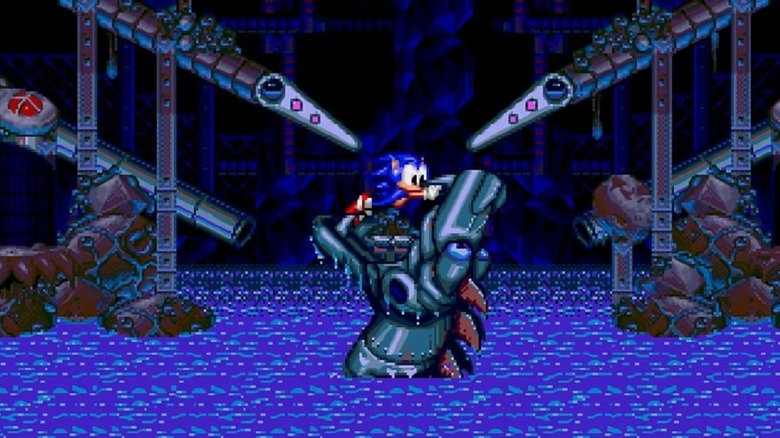 Sonic the Hedgehog holds a robotic dragon's mouth open in Sonic Spinball