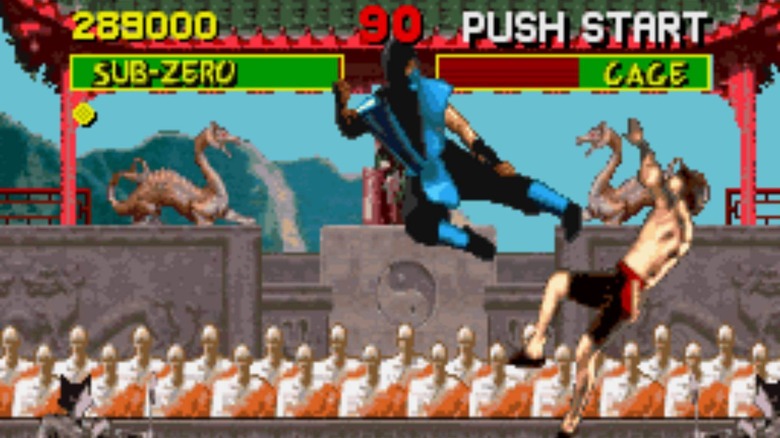 Sub-Zero kicks Johnny Cage as monks watch in Mortal Kombat