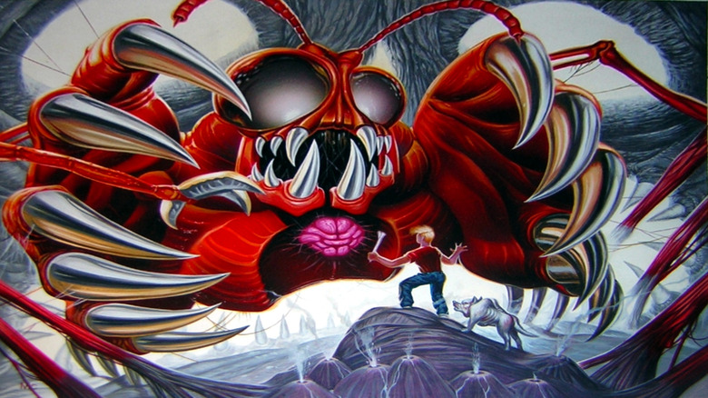 The boy and his dog face a red arachnid monster on the cover art for Secret of Evermore
