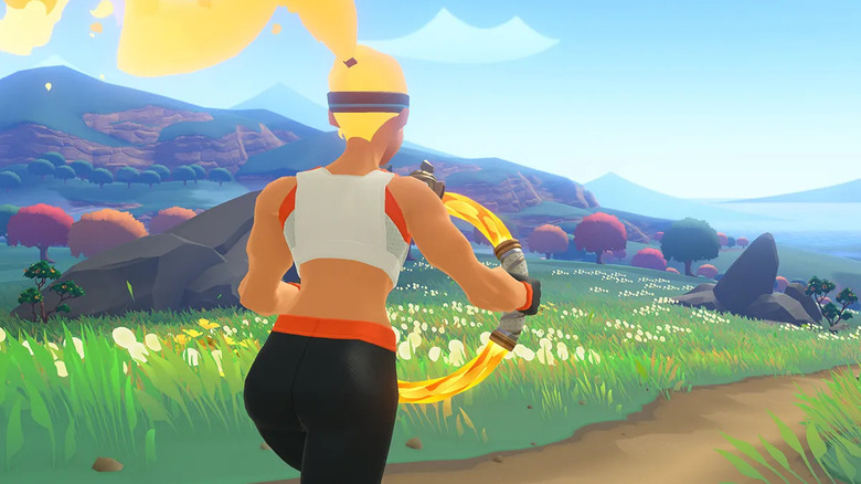 The athlete runs down a path in a grassy field while holding a glowing ring in "Ring Fit Adventure" (2019)