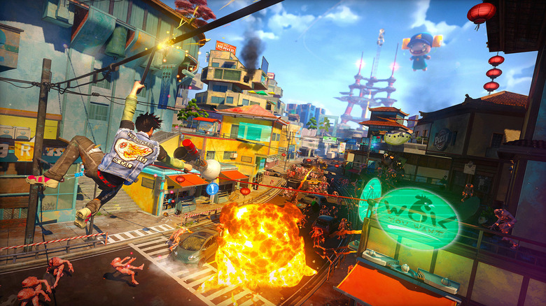 The player character hangs on a wire and shoots at an exploding street full of mutants in "Sunset Overdrive" (2014)