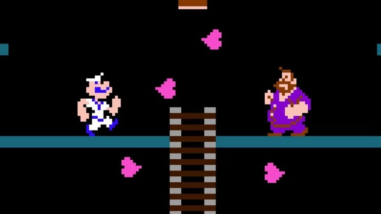 Popeye and Bluto face each other as hearts fall between them in "Popeye" (1982)