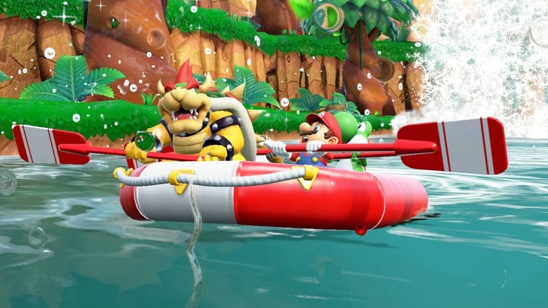 Bowser sits in a raft rowing against Mario and Yoshi in Super Mario Party