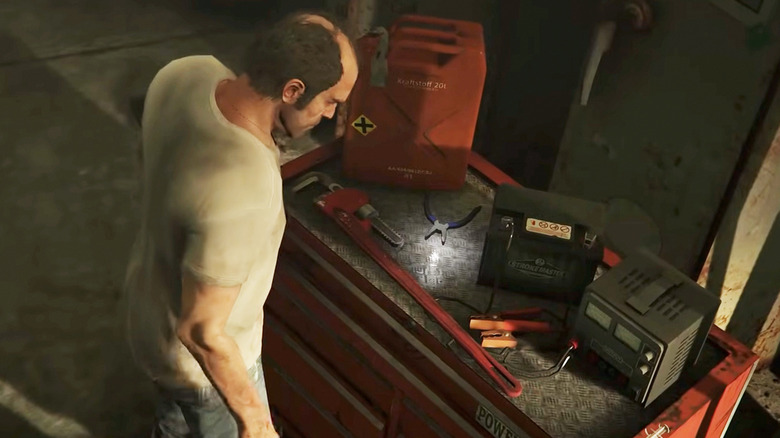 Trevor Phillips chooses from an array of torture weapons on a tool chest in Grand Theft Auto V