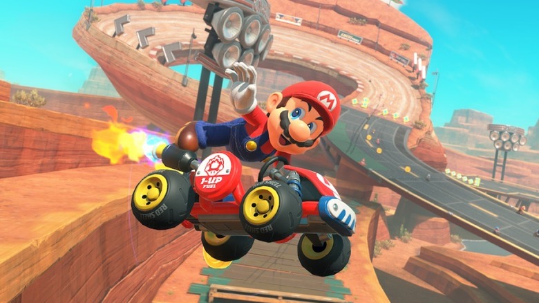 Mario soars through the air in his kart in Mario Kart World