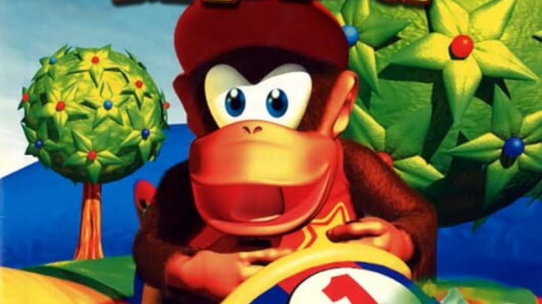 Diddy Kong smiles while piloting an airplane on the cover art for Diddy Kong Racing