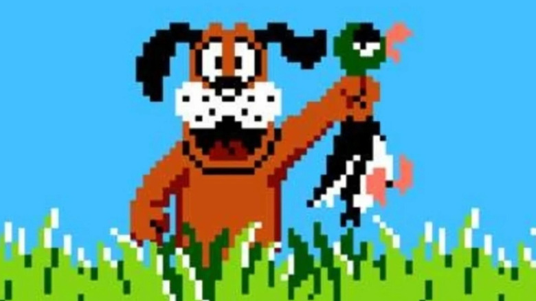 A dog triumphantly holds up a duck by the neck in Duck Hunt