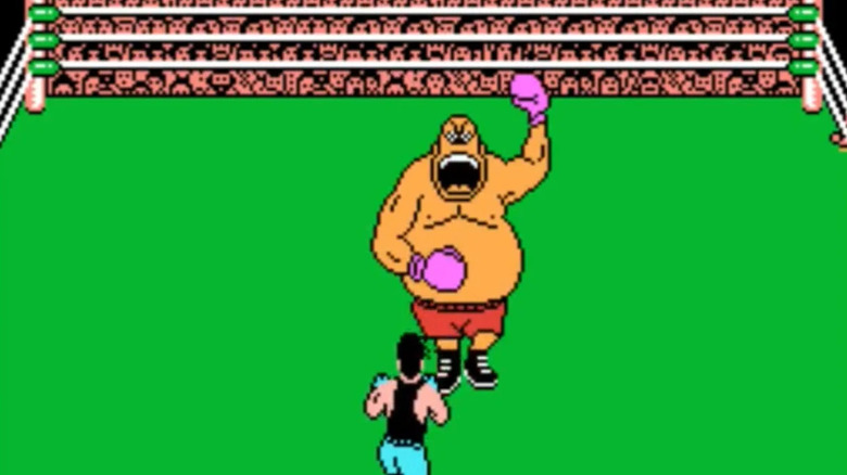 King Hippo beats his chest in front of Little Mac in Mike Tyson's Punch-Out!!