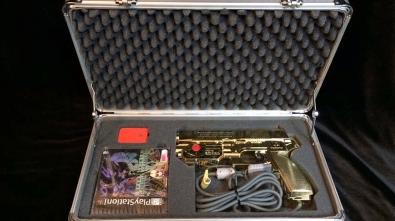 The Assassin's Case for "Elemental Gearbolt" (1997), with a gun light gun and a copy of the game