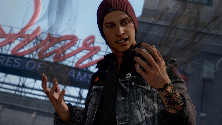 Delsin Rowe examines his hands in Infamous Second Son