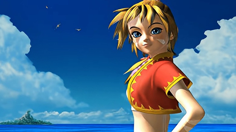 Kid looks at the camera smiling with an island in the background in Chrono Cross