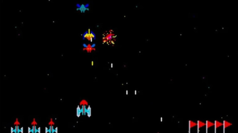 A spaceship fires at descending aliens in Galaxian