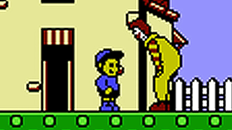 Ronald McDonald bends down to speak with a child in M.C. Kids