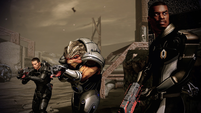Commander Shepard, Grunt, and Jacob Taylor advance with guns ready in "Mass Effect 2" (2010)