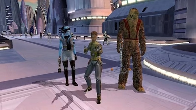 A Jedi is flanked by Mission Vao and Zaalbar on a futuristic walkway in "Star Wars: Knights of the Old Republic" (2003)