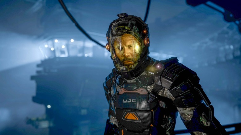 Jacob Lee stands wearing a damaged environmental suit in The Callisto Protocol