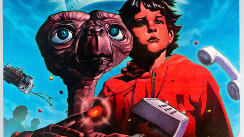 E.T. and Elliott Taylor stand among flying pieces of a telephone on the cover art for E.T. the Extra-Terrestrial