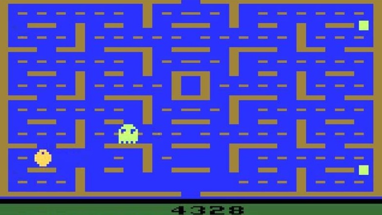 A ghost advances on Pac-Man in a crude maze in Pac-Man on the Atari 2600