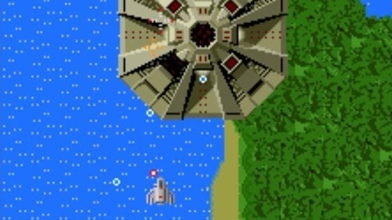 A spaceship approaches a mothership hovering over an island in Xevious