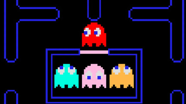 A red ghost emerges from a cell in Pac-Man