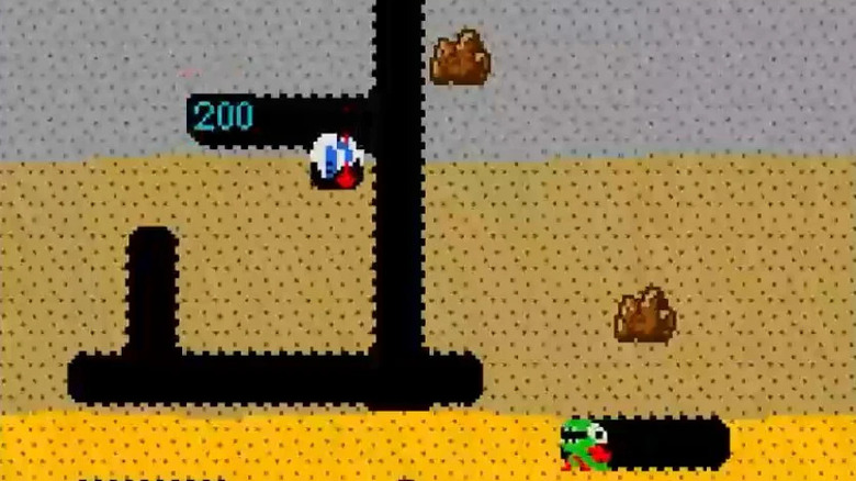 Dig Dug burrows downward around boulders in "Dig Dug" (1982)