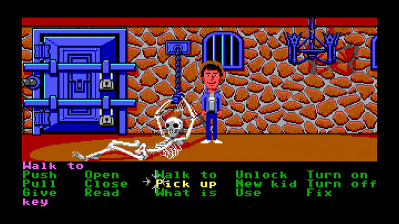 Dave Miller stands next to a skeleton chained to a wall in Maniac Mansion