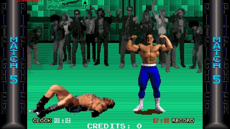 Buzz flexes his muscles over a defeated Chainman Eddie before an adoring crowd in Pit-Fighter