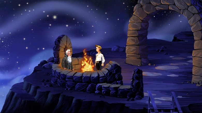 Guybrush Threepwood speaks to a man by a campfire on a cliff in The Secret of Monkey Island