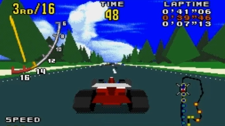 A red car races through a road in a forest in "Virtua Racing" (1992)